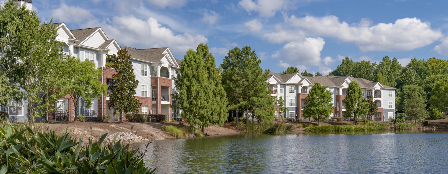 a body of water surrounded by buildings and trees