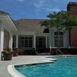 resort style pool with a building behind