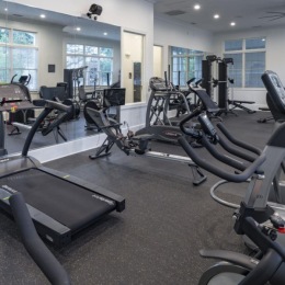 a gym with exercise equipment and mirrors