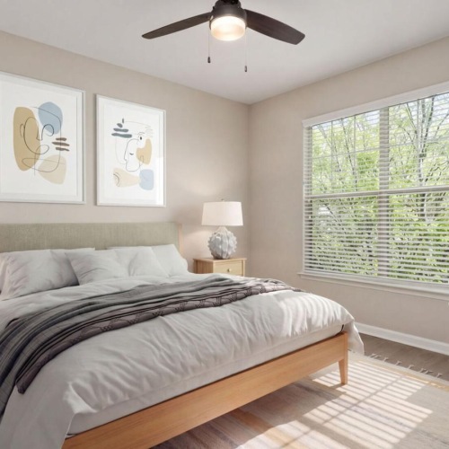 a bedroom with a bed lamps windows and a ceiling fan