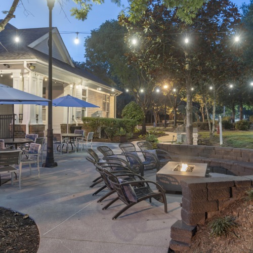 patio with seating fire pit and a string of lights