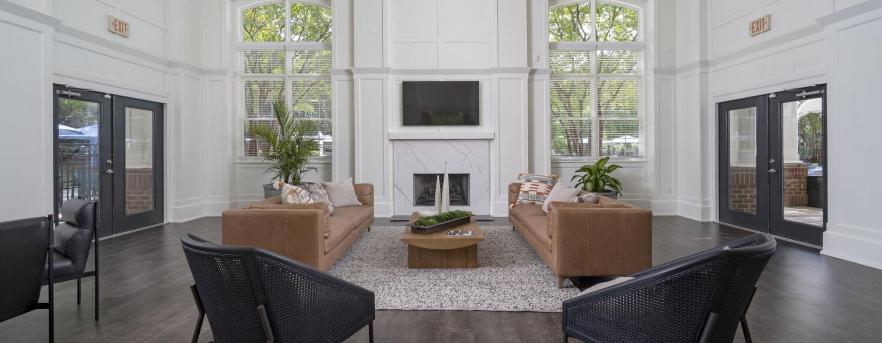 a lounge with a fireplace tv and seating